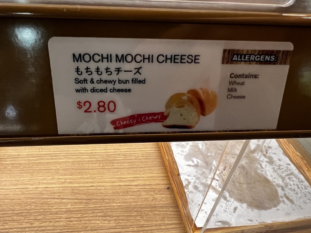 Close-up of a Mochi Mochi Cheese bun label with price and allergen details.