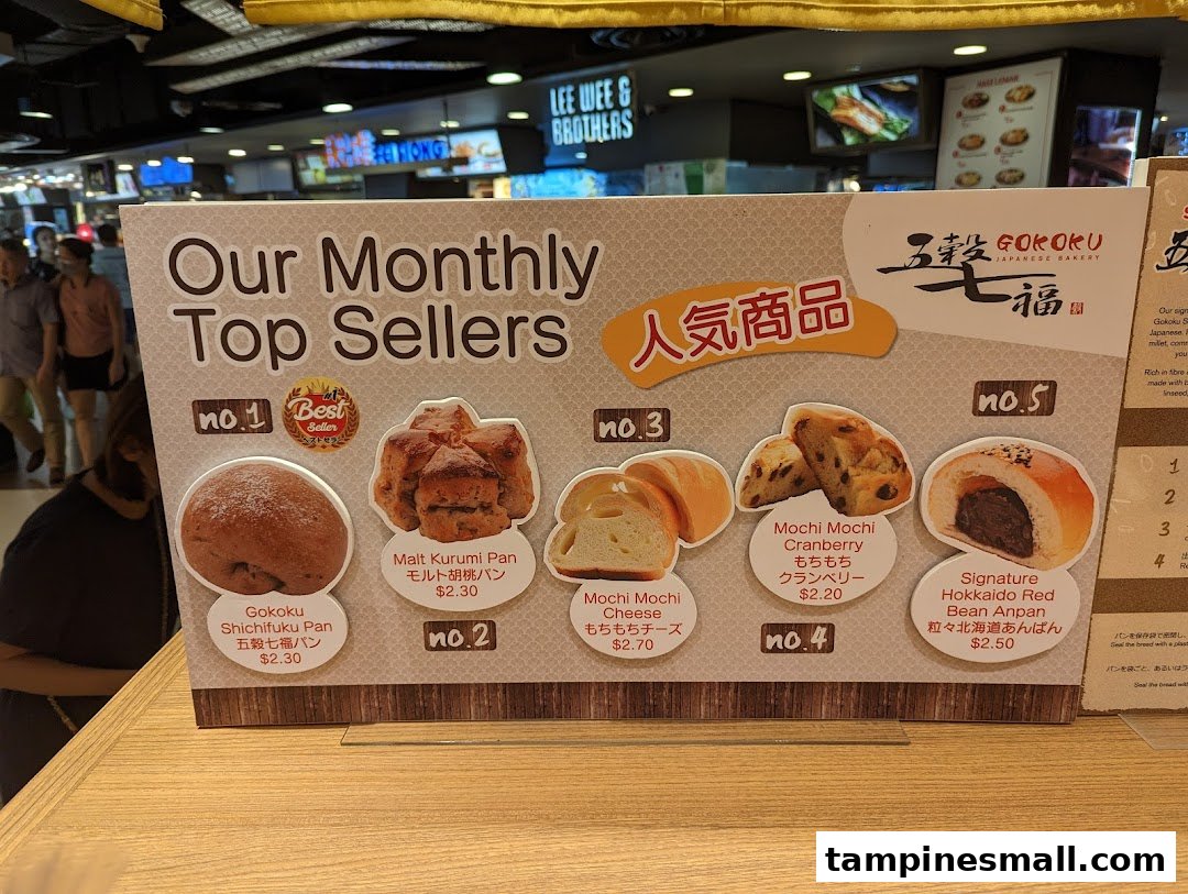 A display board showcasing Gokoku Japanese Bakery's monthly top-selling bread items with prices.