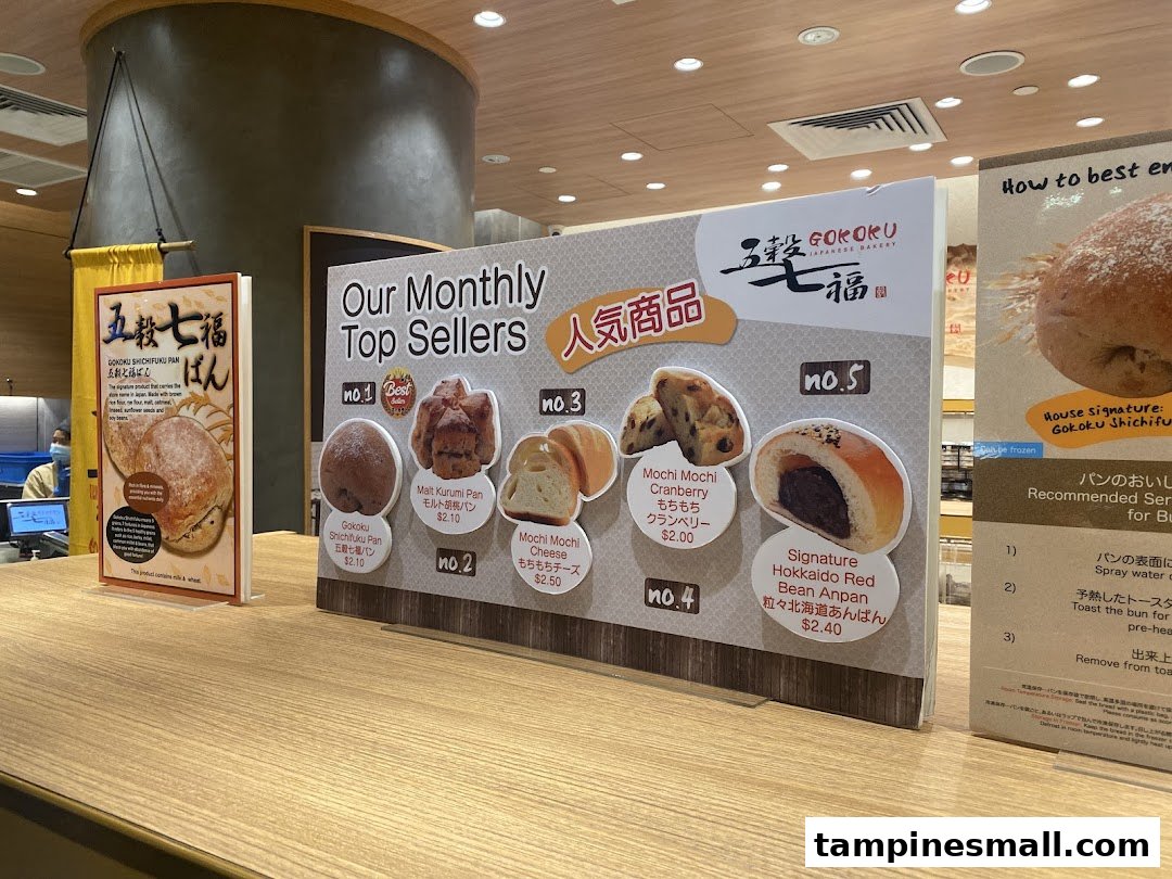 A display board showcasing Gokoku Japanese Bakery's monthly top-selling bread items with prices.