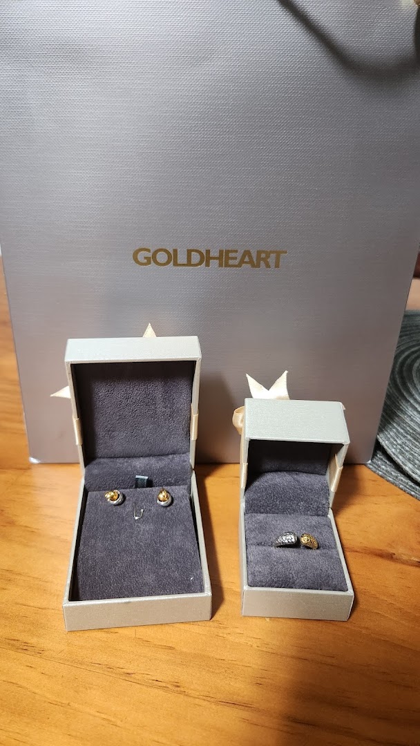 Goldheart Jewelry bag with open boxes displaying elegant earrings and a ring.