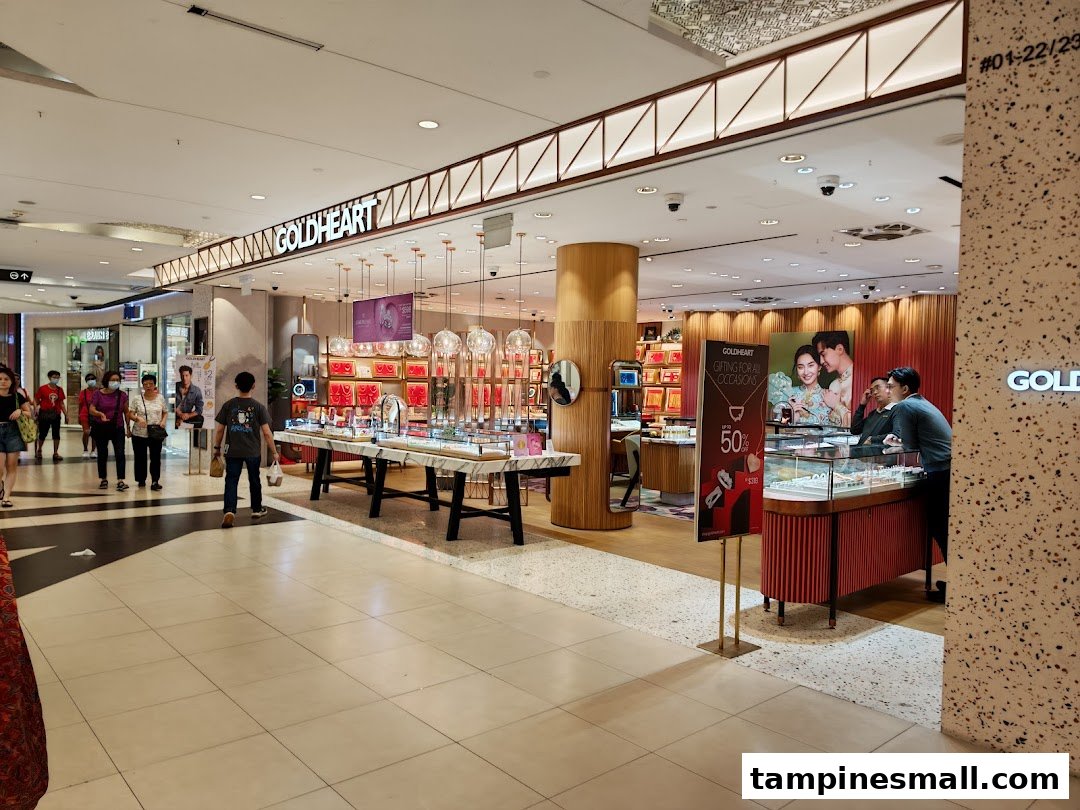 The Goldheart Jewelry shop entrance in Tampines Mall, showcasing elegant displays and inviting customers.