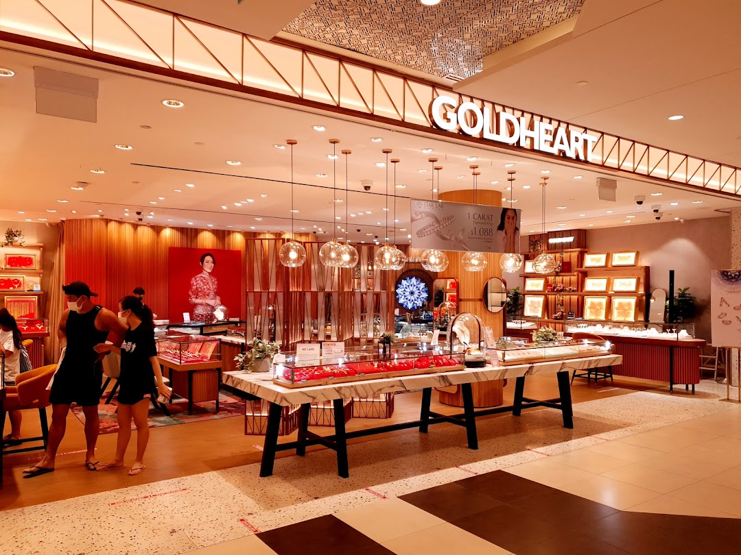 The brightly lit interior of Goldheart Jewelry, showcasing elegant displays and customers browsing.