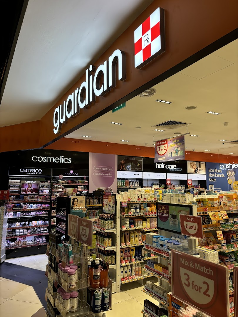 An interior view of Guardian Health & Beauty, showcasing cosmetics, hair care, and various health products with promotional signage.