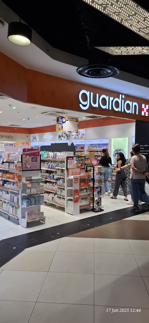 The entrance of Guardian Health & Beauty store, showcasing various health and beauty products.