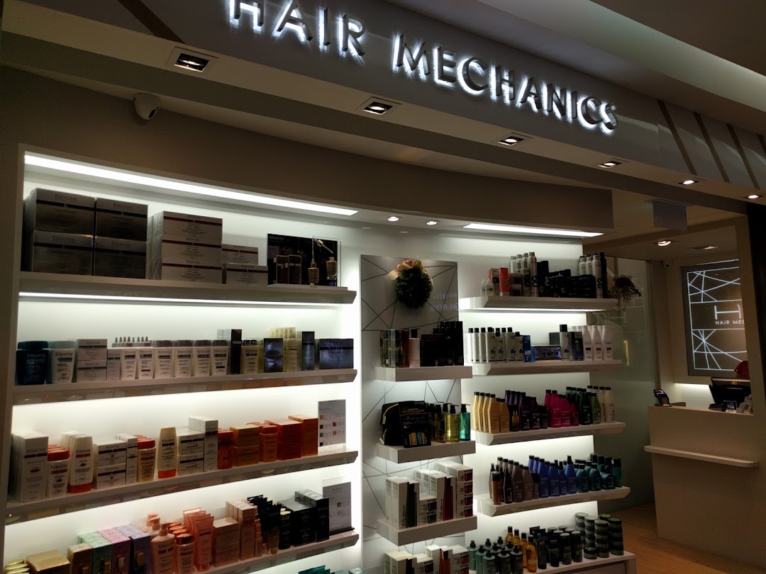 Interior view of Hair Mechanics showcasing a wide array of hair care products on brightly lit shelves.