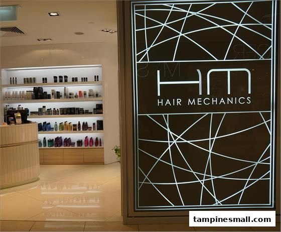 The image shows the modern entrance of Hair Mechanics salon with a view of product shelves inside.
