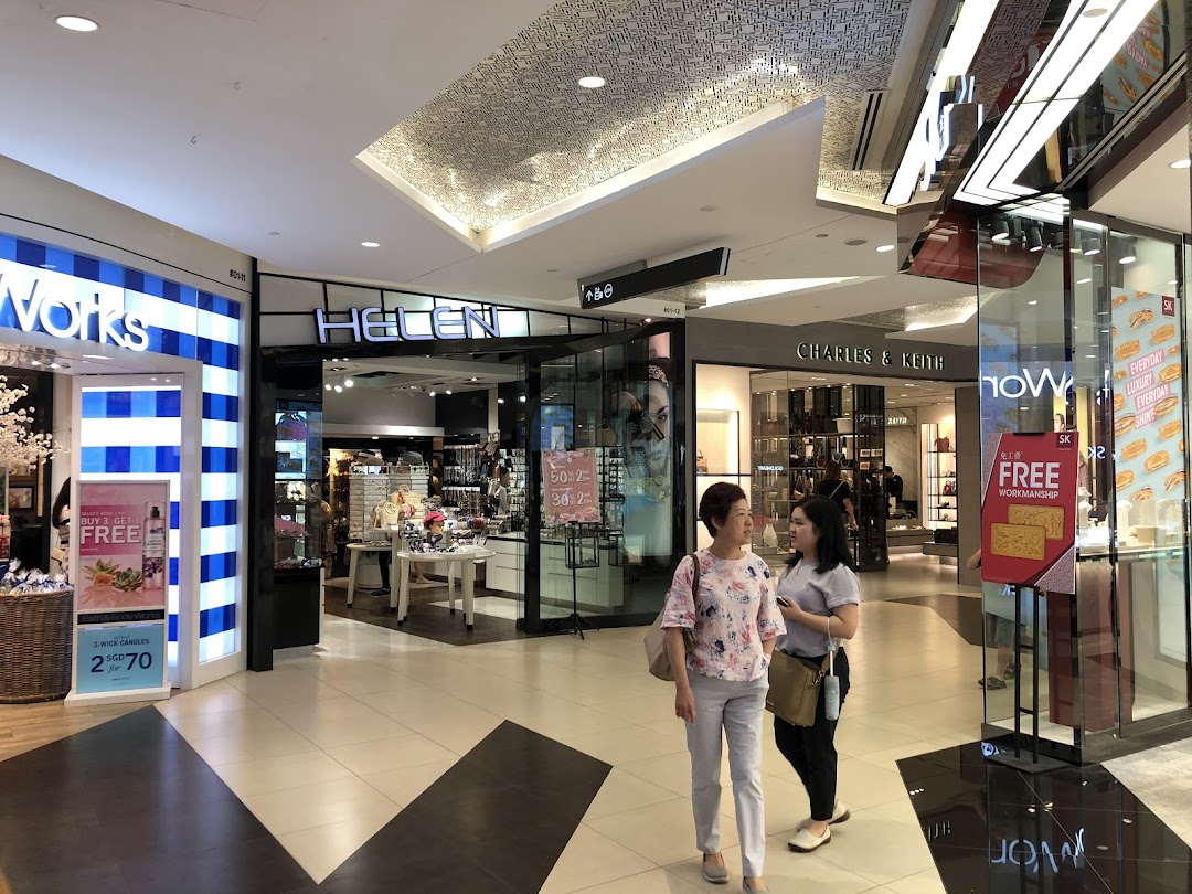 Exterior view of Helen Tampines Mall entrance, showcasing accessories and gifts in a vibrant mall setting.