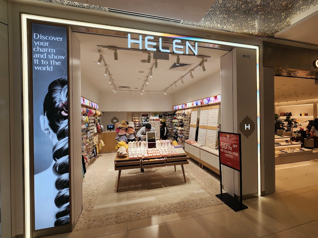 The brightly lit entrance of Helen, an accessories shop, showcasing various jewelry and hair accessories.
