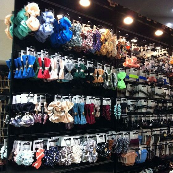 A vibrant wall display showcasing a wide variety of colorful hair accessories and clips.