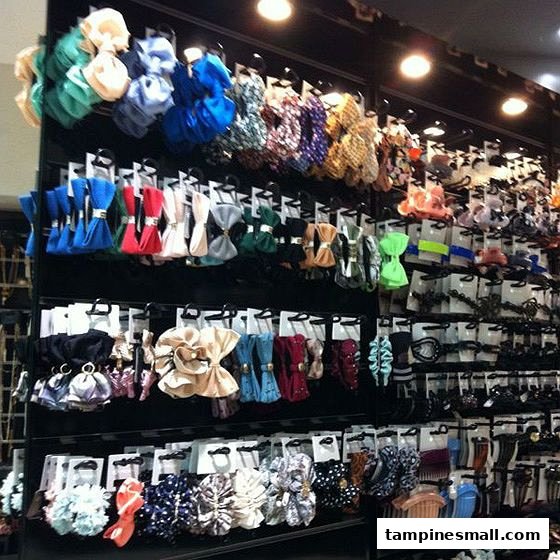 A vibrant wall display showcasing a wide variety of colorful hair accessories and clips.