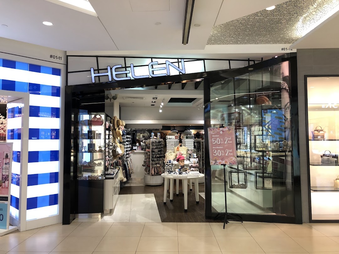 The Helen shop entrance at Tampines Mall, showcasing a wide array of fashion accessories and a sale sign.
