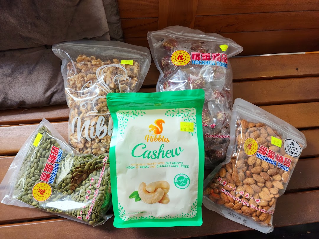 A variety of packaged nuts and seeds, including cashews, walnuts, almonds, and pumpkin seeds.