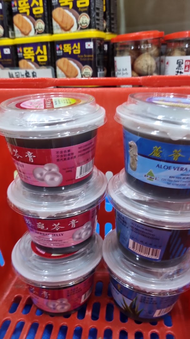 Close-up of various packaged health and wellness products, including herbal jellies, in a red shopping basket.