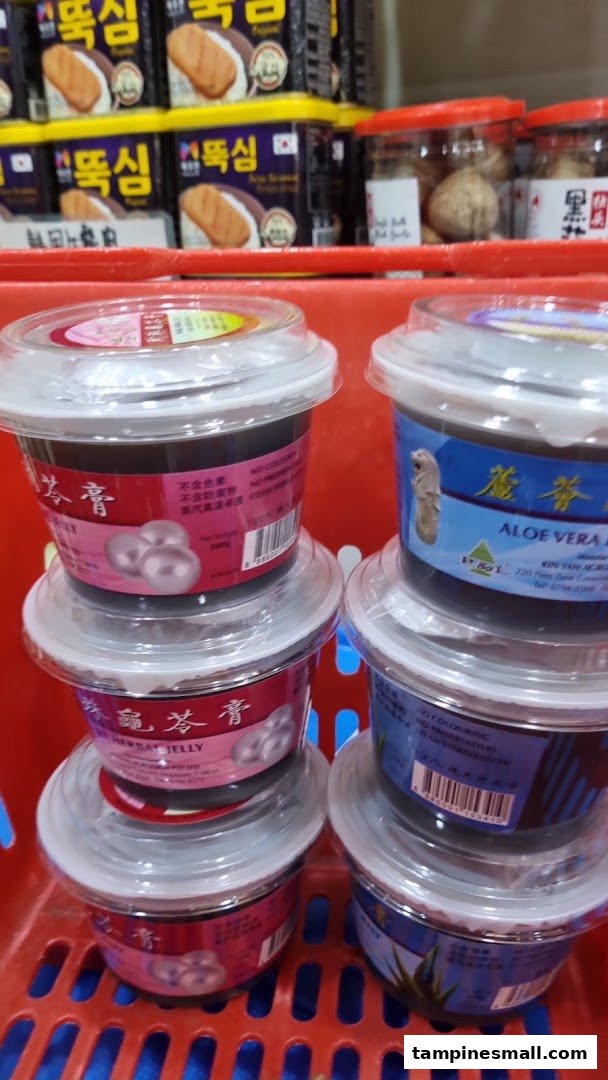 Close-up of various packaged health and wellness products, including herbal jellies, in a red shopping basket.