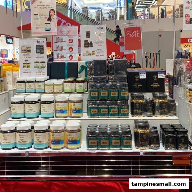A retail display showcasing various HoneyWorld products like Manuka honey, collagen, royal jelly, and propolis.