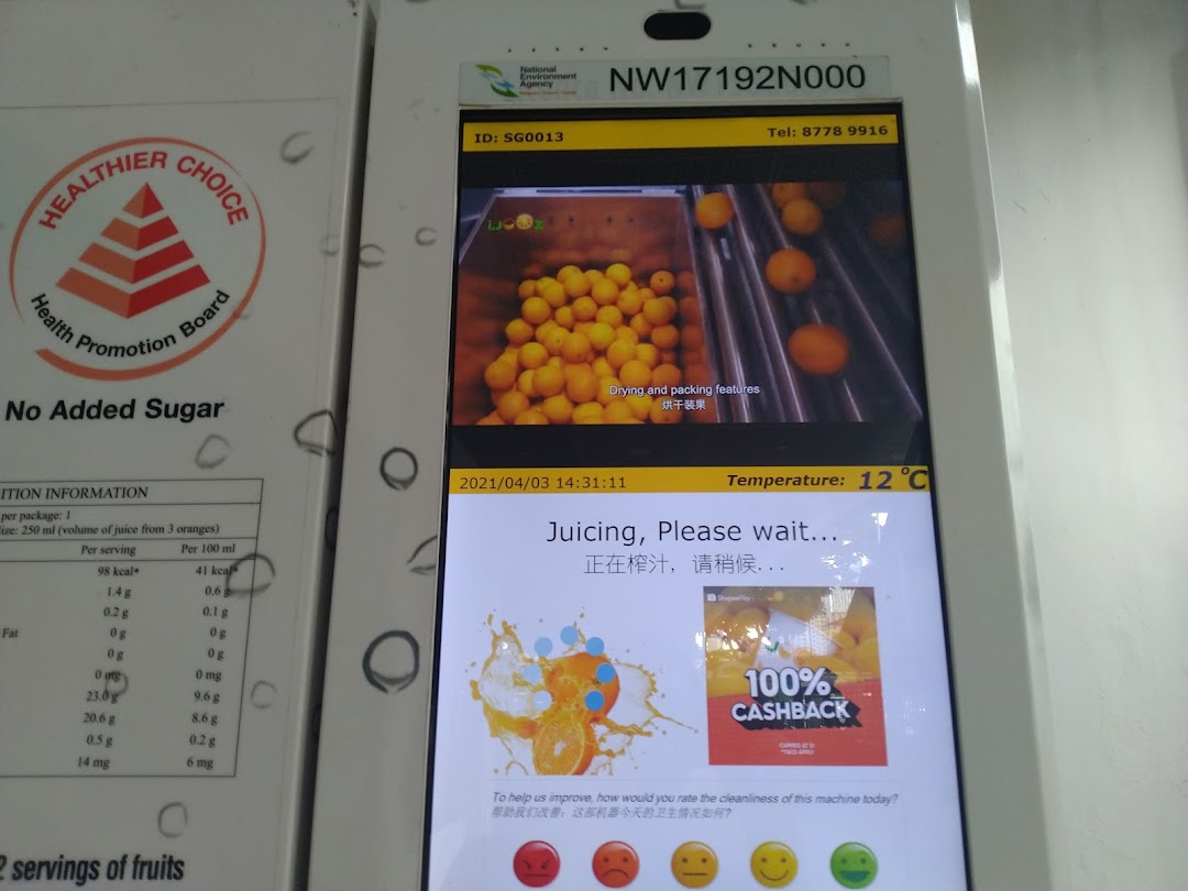 A self-service iJooz machine displaying nutritional information and the fresh juicing process.