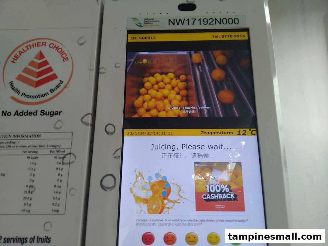 A self-service iJooz machine displaying nutritional information and the fresh juicing process.