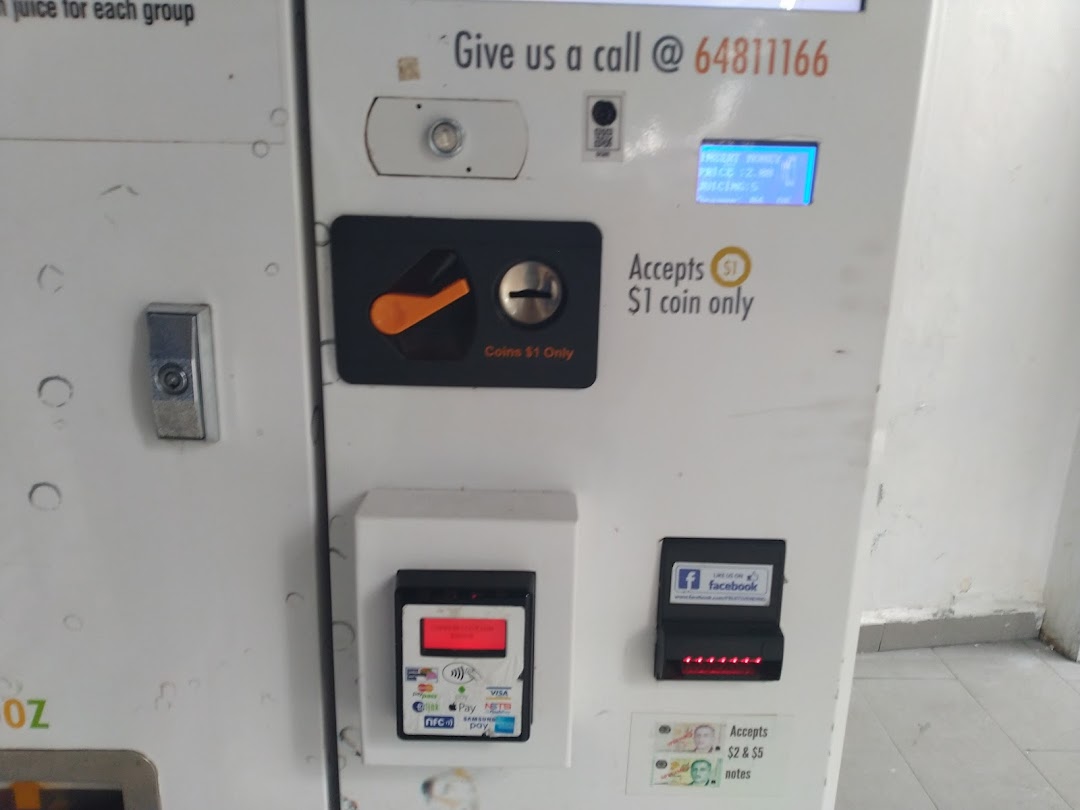 Close-up of an iJooz juice vending machine's payment interface, showing various coin, note, and digital payment options.
