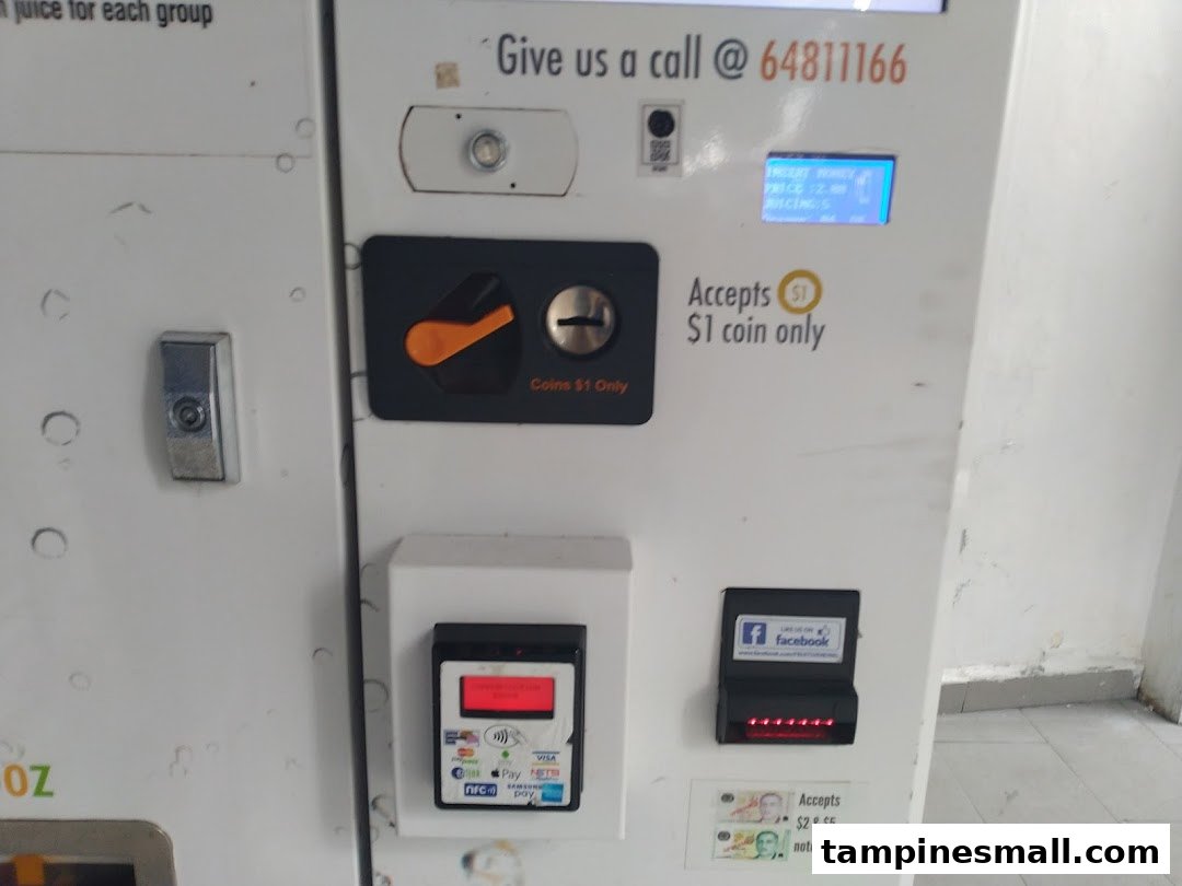 Close-up of an iJooz juice vending machine's payment interface, showing various coin, note, and digital payment options.