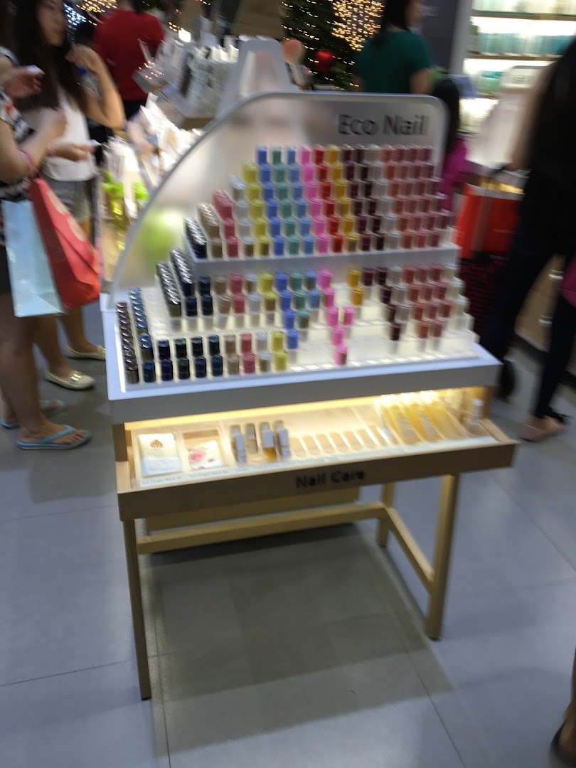 A vibrant display stand showcasing Innisfree's 'Eco Nail' polishes and 'Nail Care' products.