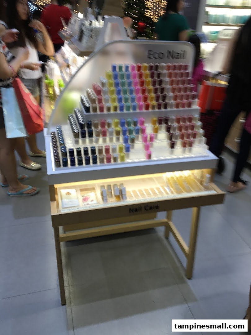 A vibrant display stand showcasing Innisfree's 'Eco Nail' polishes and 'Nail Care' products.