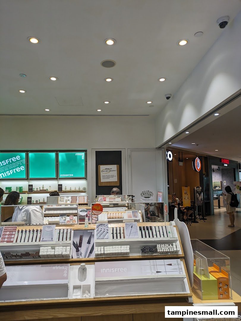 Interior view of Innisfree, featuring well-lit displays of skincare and makeup products, with customers browsing.