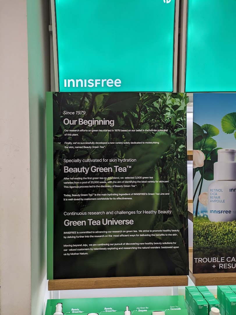 An Innisfree in-store display highlighting the origins and benefits of their signature Beauty Green Tea ingredient.