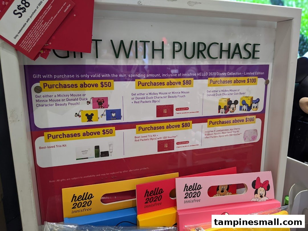 A display board showcasing Innisfree's 'Gift with Purchase' promotions featuring Disney characters and beauty kits.