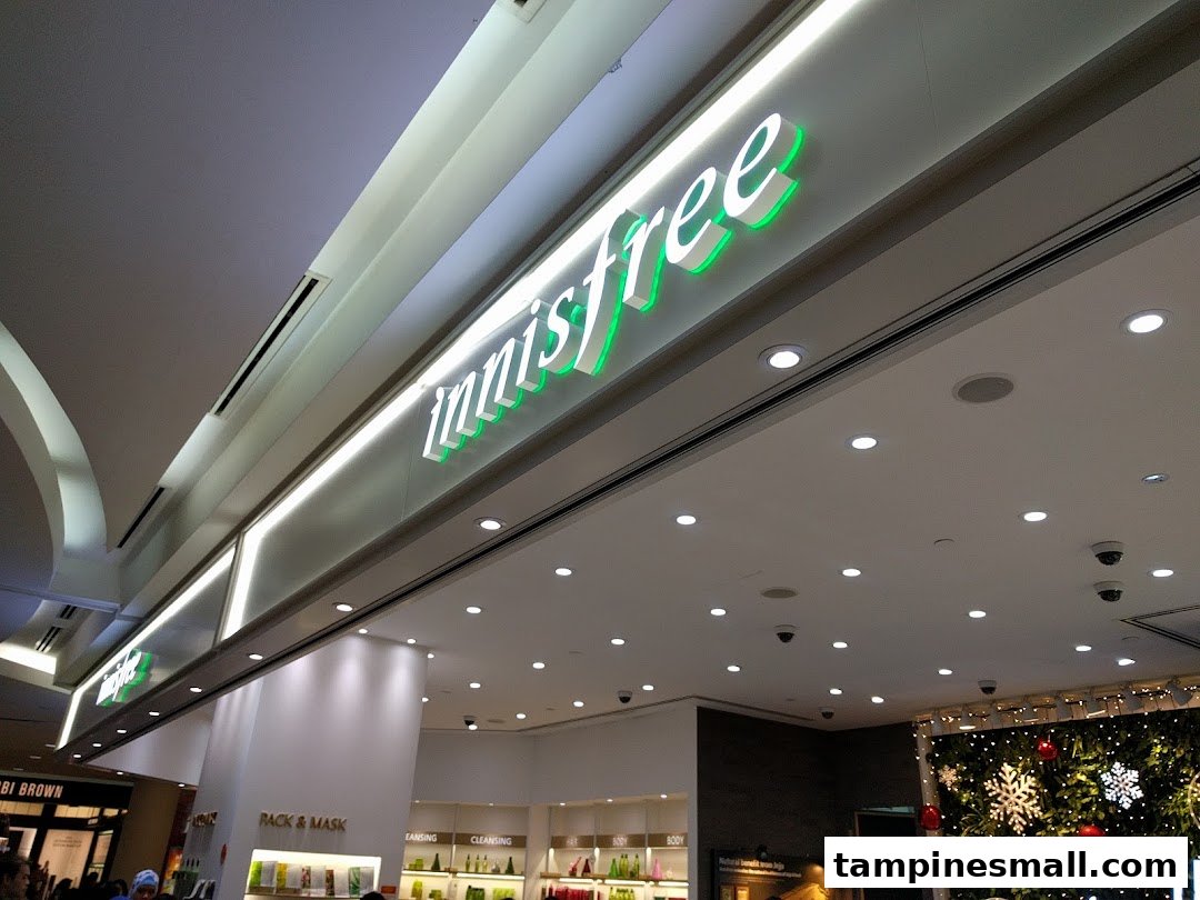 The innisfree shop entrance with its distinctive green and white illuminated signage.