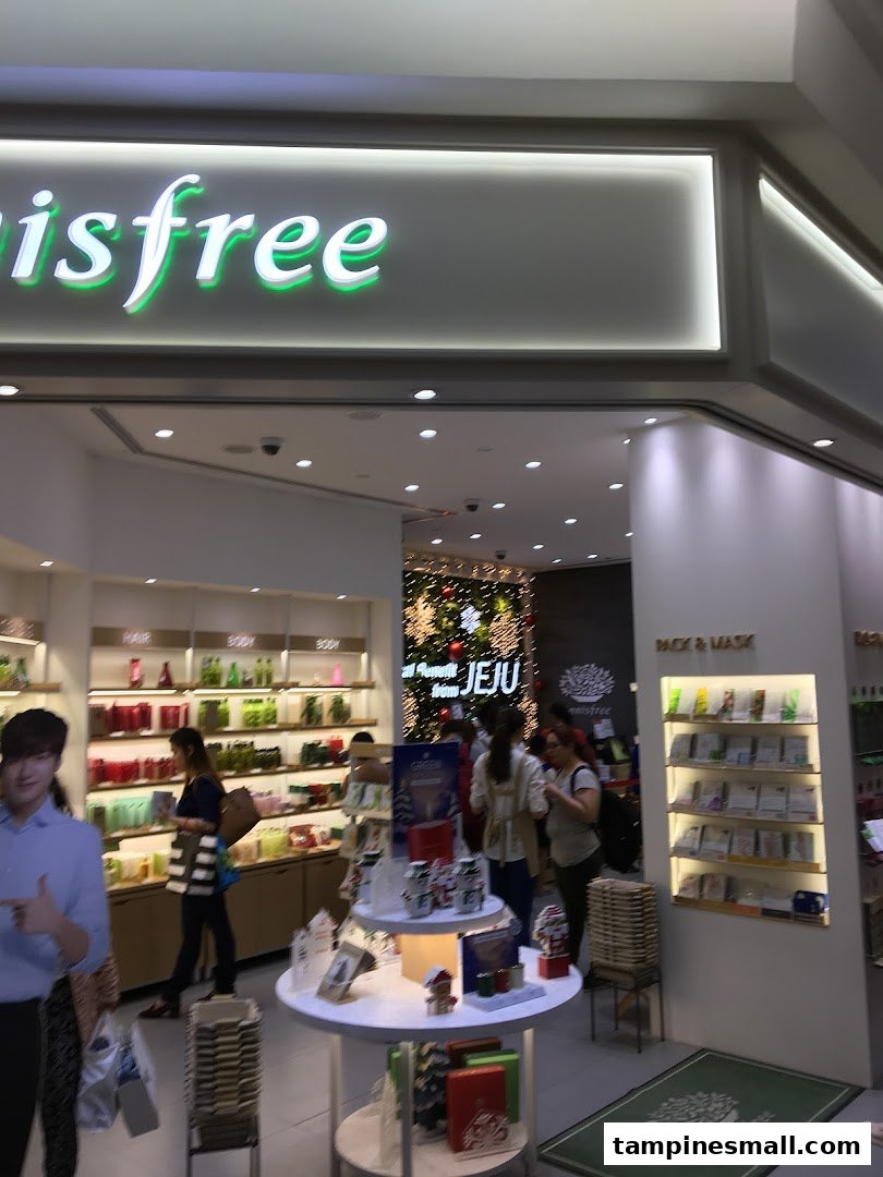 The Innisfree shop entrance showcasing skincare products, a festive display, and customers browsing.