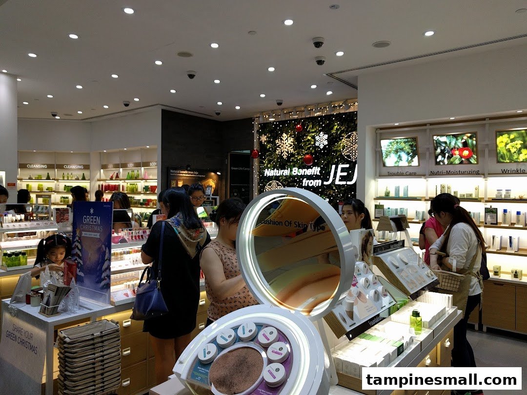 Customers browse natural skincare and makeup products in a brightly lit Innisfree store, featuring festive decorations.