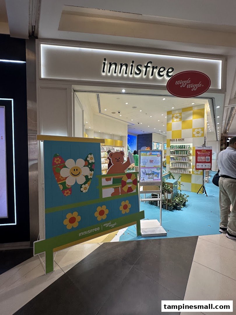 The Innisfree shop entrance features a vibrant Wiggle Wiggle collaboration display with a teddy bear.