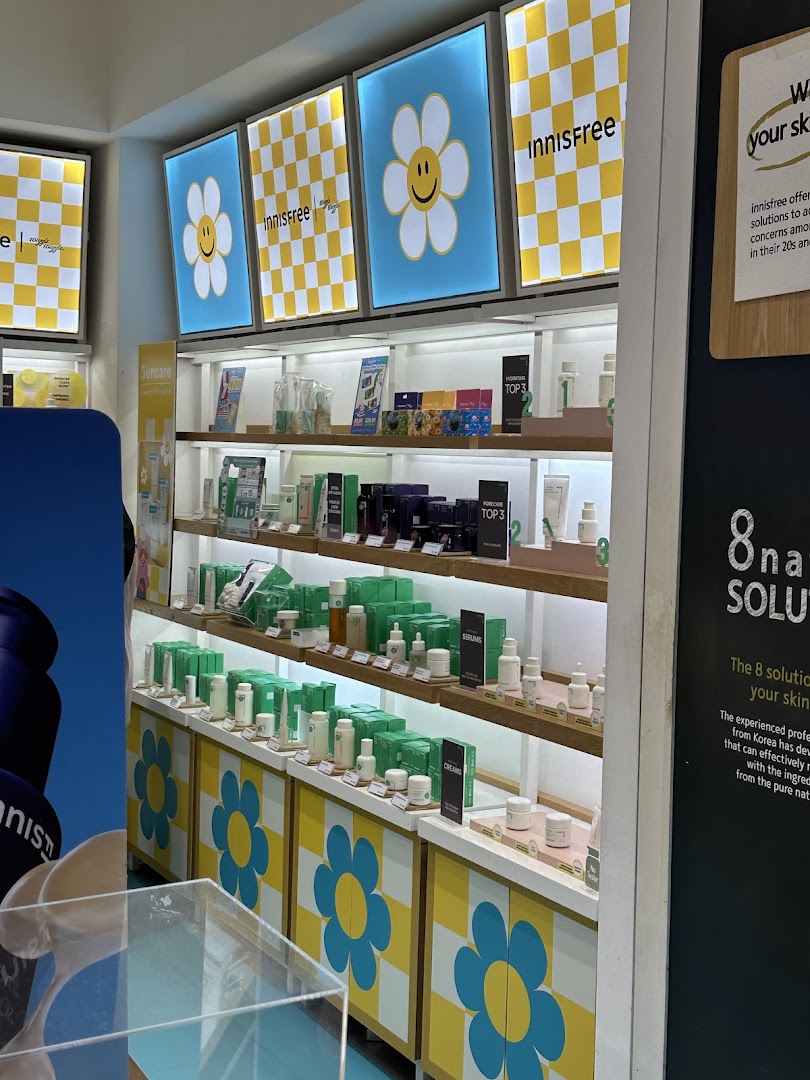 Interior view of Innisfree showcasing shelves filled with skincare products and cheerful daisy-themed decor.