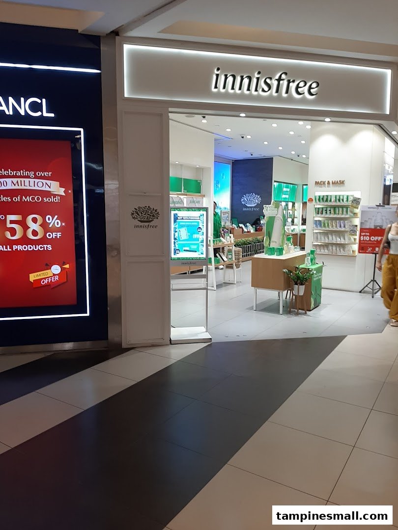The image shows the brightly lit entrance of the innisfree beauty store with product displays visible inside.