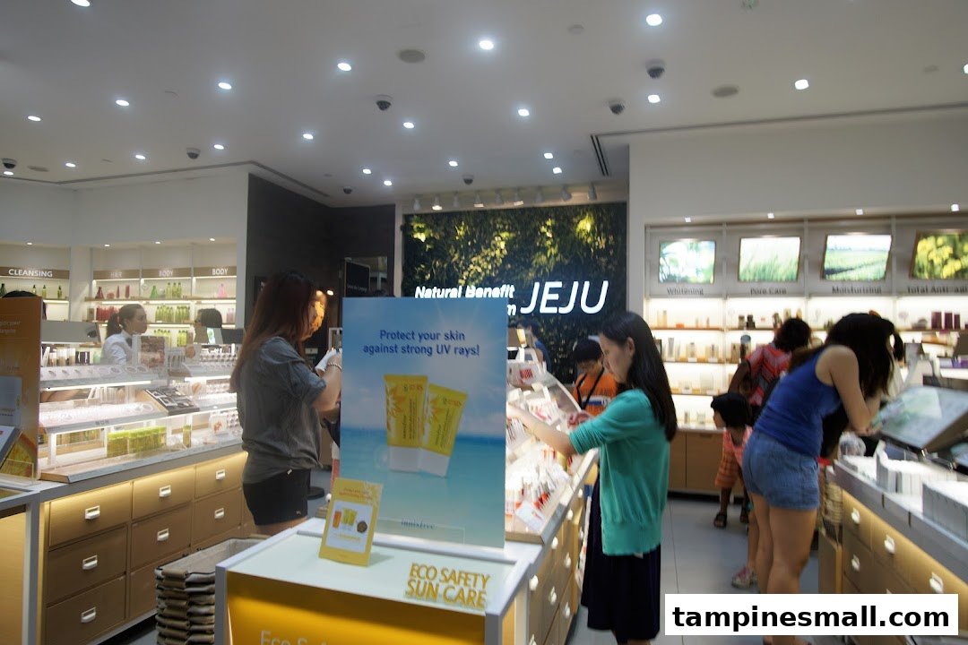 Customers browse skincare and beauty products inside a brightly lit Innisfree store featuring natural Jeju-inspired displays.