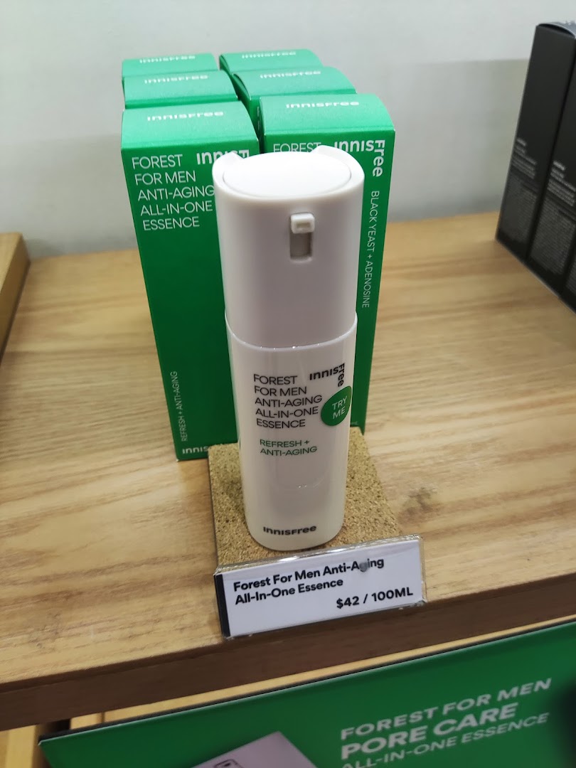 A display of Innisfree's Forest For Men Anti-Aging All-In-One Essence with product boxes and pricing.