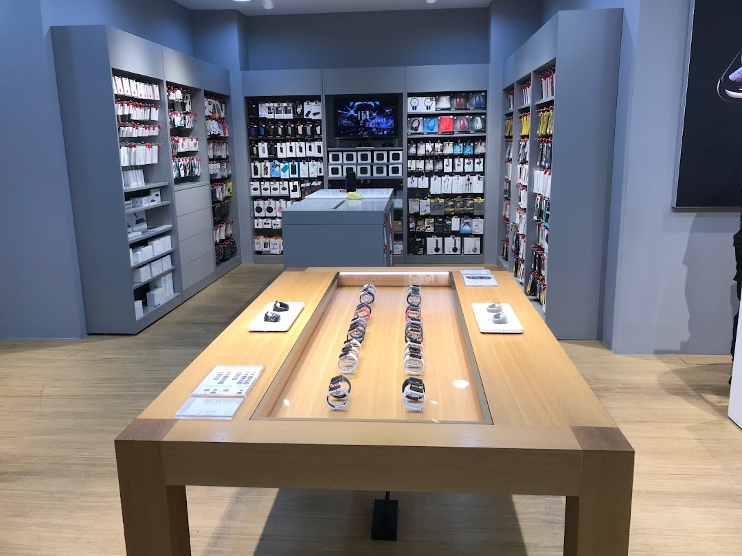 Interior view of iStudio, showcasing Apple Watches on display and shelves filled with accessories.