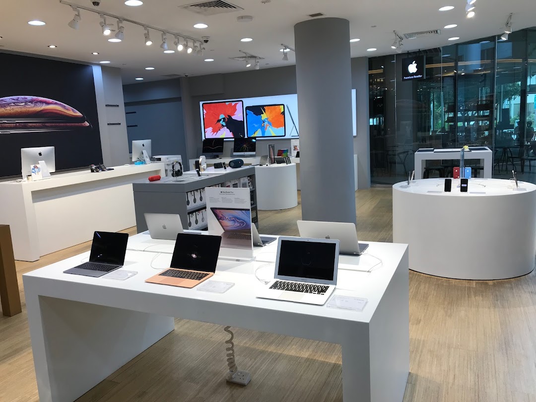 Interior view of iStudio Tampines Mall, an Apple Premium Reseller, showcasing various Apple products on display.