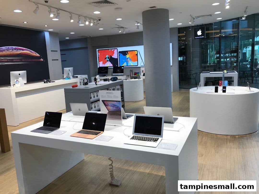 Interior view of iStudio Tampines Mall, an Apple Premium Reseller, showcasing various Apple products on display.