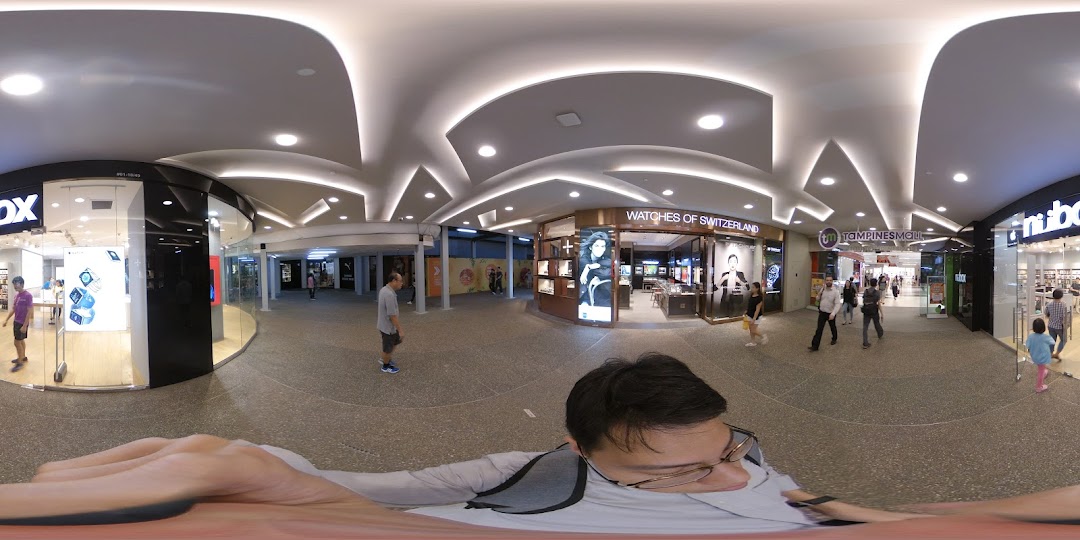 The shop front of iStudio, an Apple Premium Reseller, showcasing products in Tampines Mall.