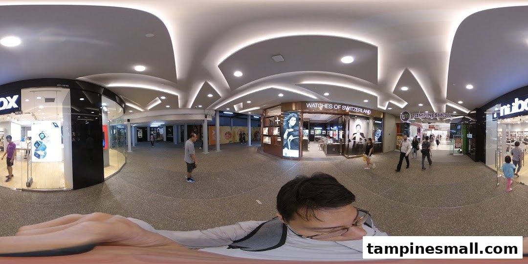 The shop front of iStudio, an Apple Premium Reseller, showcasing products in Tampines Mall.
