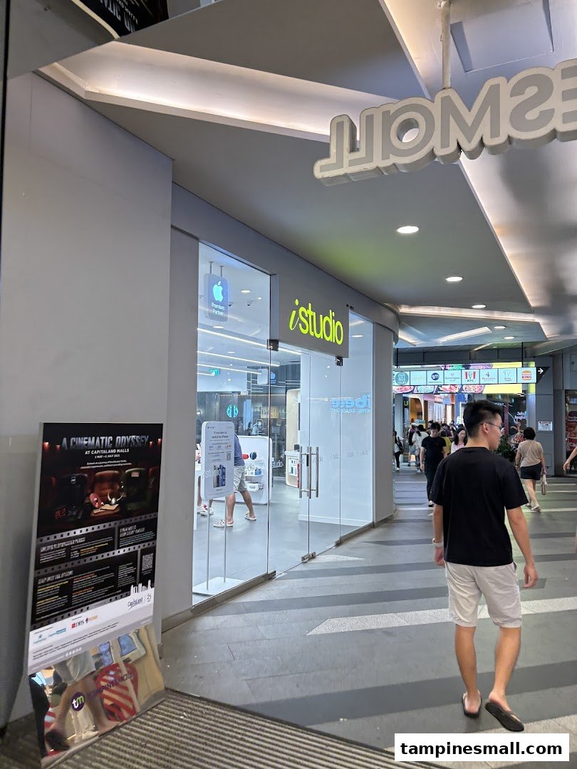 The iStudio shop front with its glass entrance and Apple logo, located in a mall corridor.