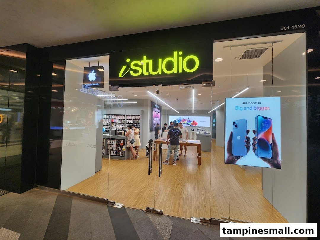 The iStudio shopfront features a bright interior, displaying Apple products and accessories.
