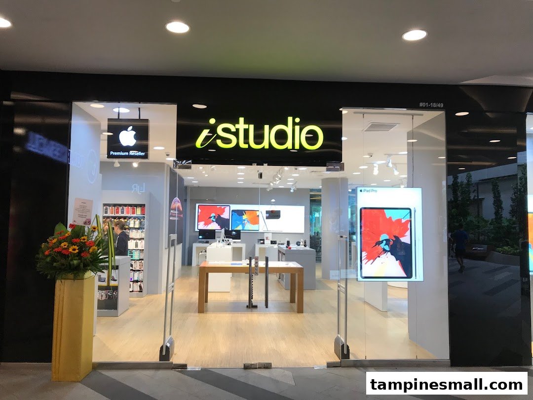 The iStudio shop front with its bright logo, glass entrance, and Apple Premium Reseller sign.