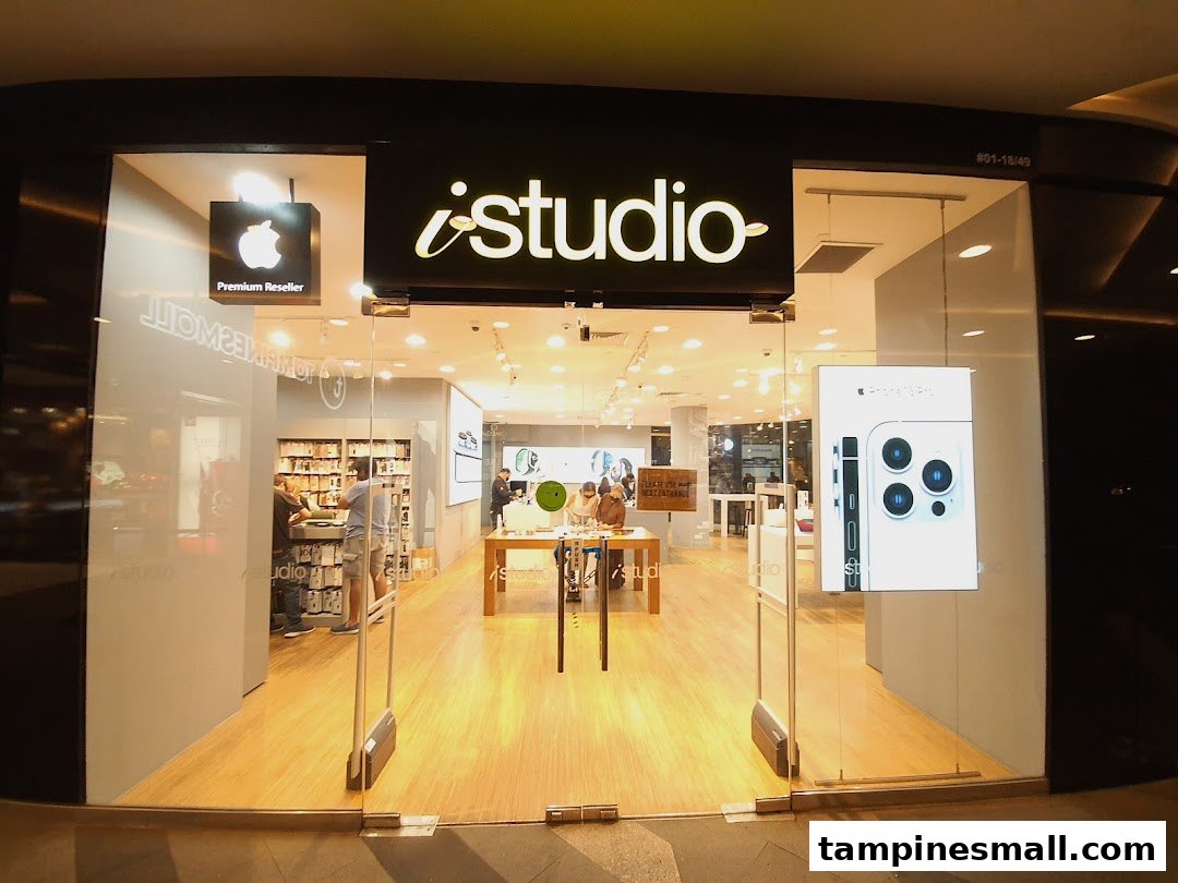 The brightly lit iStudio storefront showcasing Apple products and a 'Premium Reseller' sign.