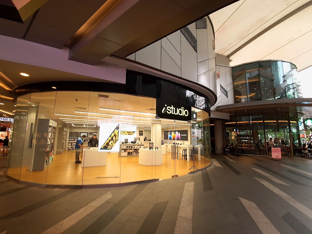 The iStudio shop front at Tampines Mall, showcasing its modern glass exterior and Apple products.