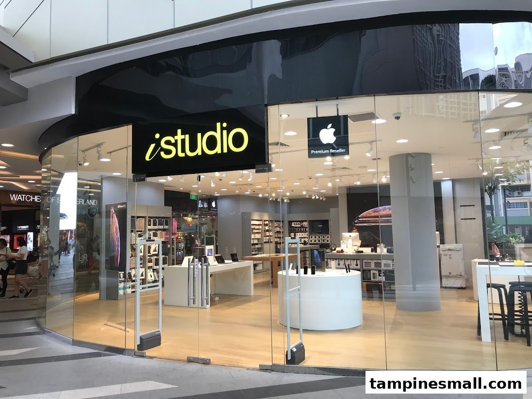 The iStudio shop front at Tampines Mall, an Apple Premium Reseller, with a clear glass facade.