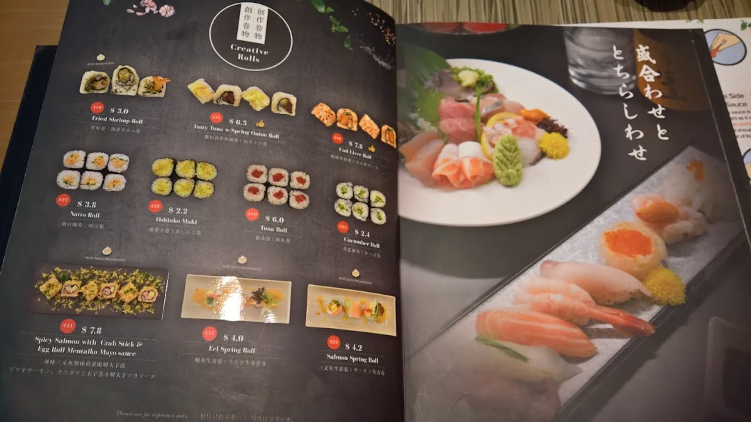An open menu from Itacho Sushi showcasing a variety of creative sushi rolls and sashimi platters.