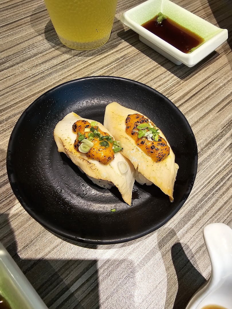 Two pieces of delicious sushi with savory toppings on a black plate, ready to be enjoyed at Itacho Sushi.