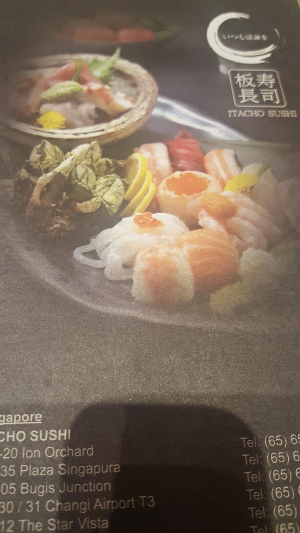 A menu page displaying vibrant sushi and sashimi platters alongside Itacho Sushi's Singapore location details.